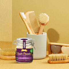Damp toothbrush dipping into The Dirt tooth powder