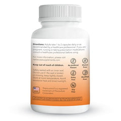 Turmeric capsules next to a scoop of turmeric powder