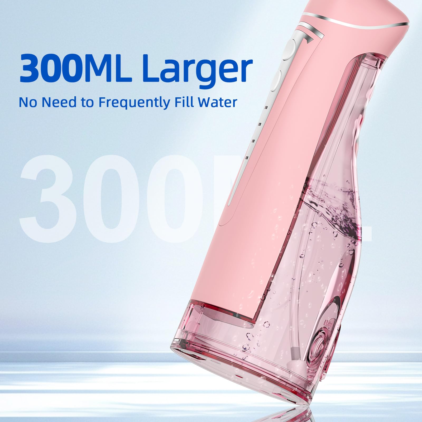 Compact portable water flosser in pink with nozzle attached