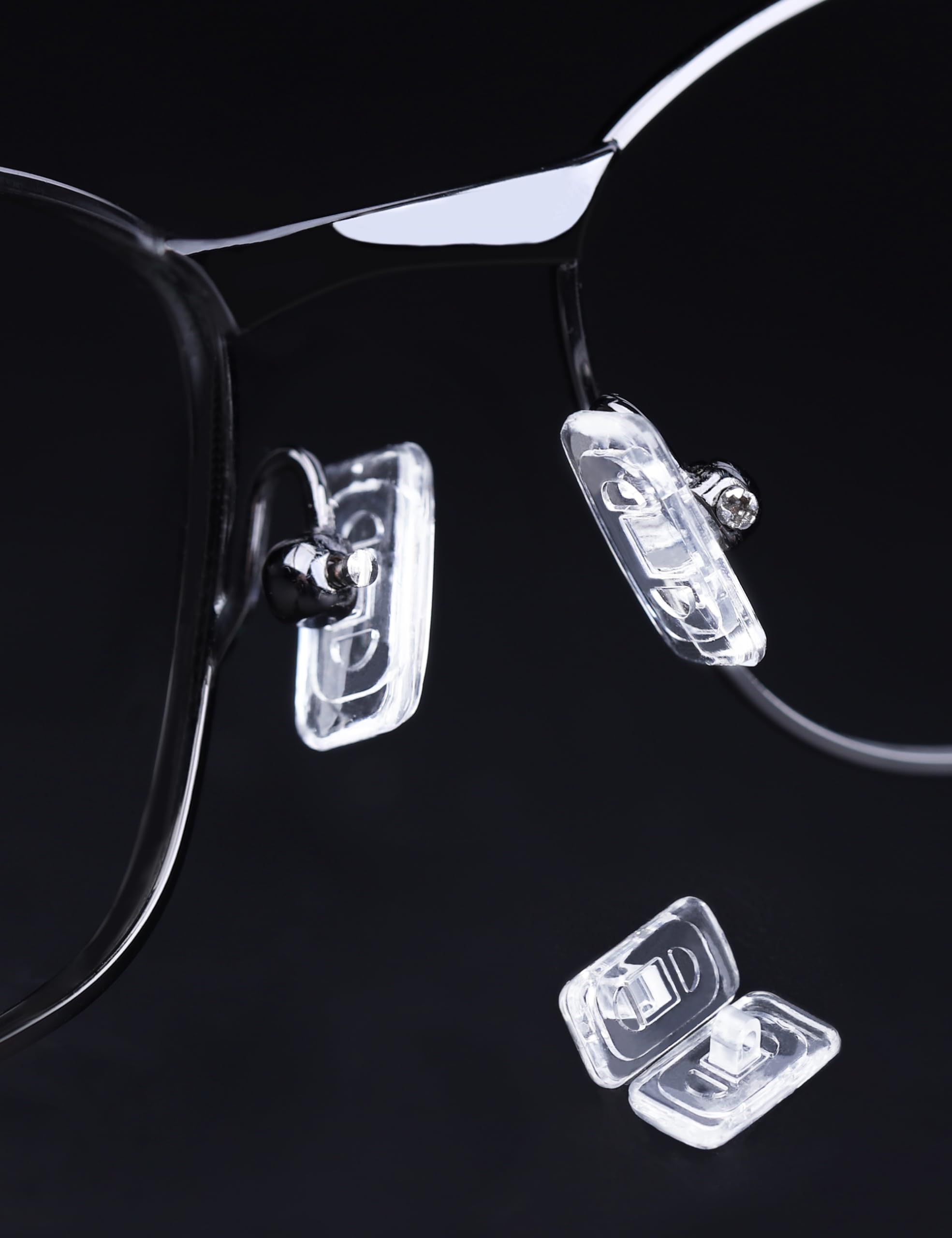Close-up of screws and micro screwdriver included with Tolaxy nose pads