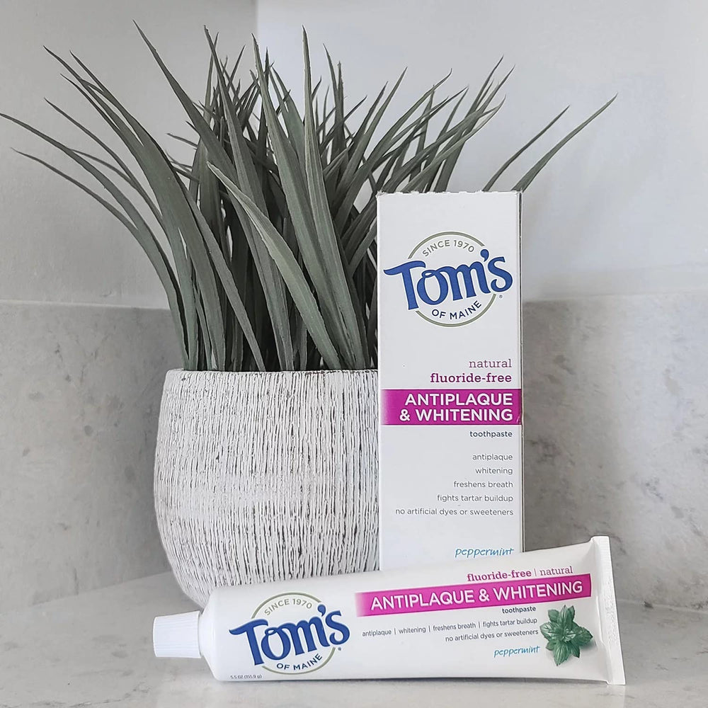Mint leaves beside Tom's of Maine toothpaste to emphasize peppermint flavor