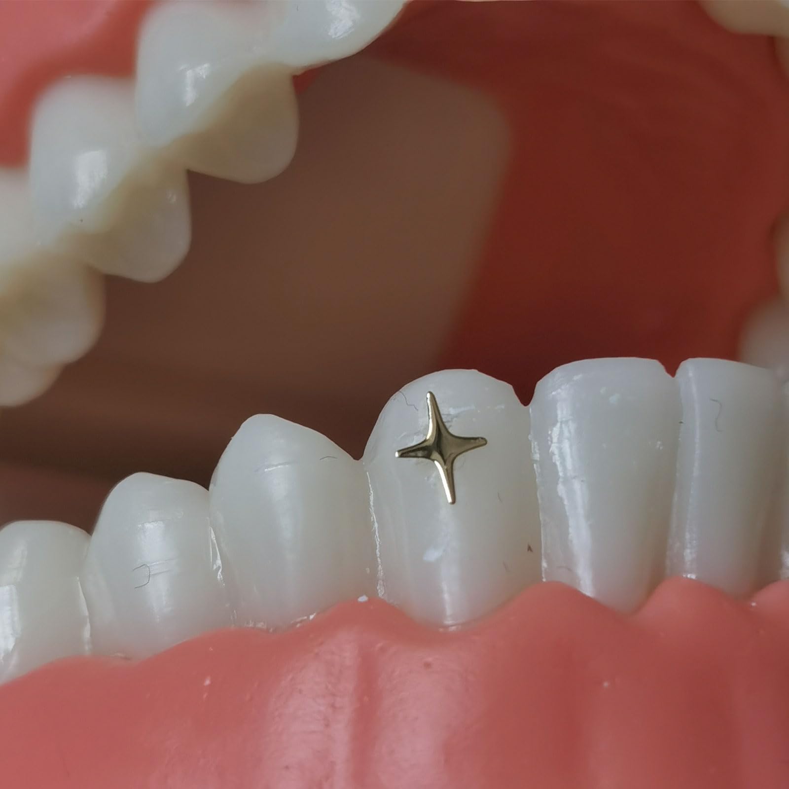 Silver-toned tooth gems close-up