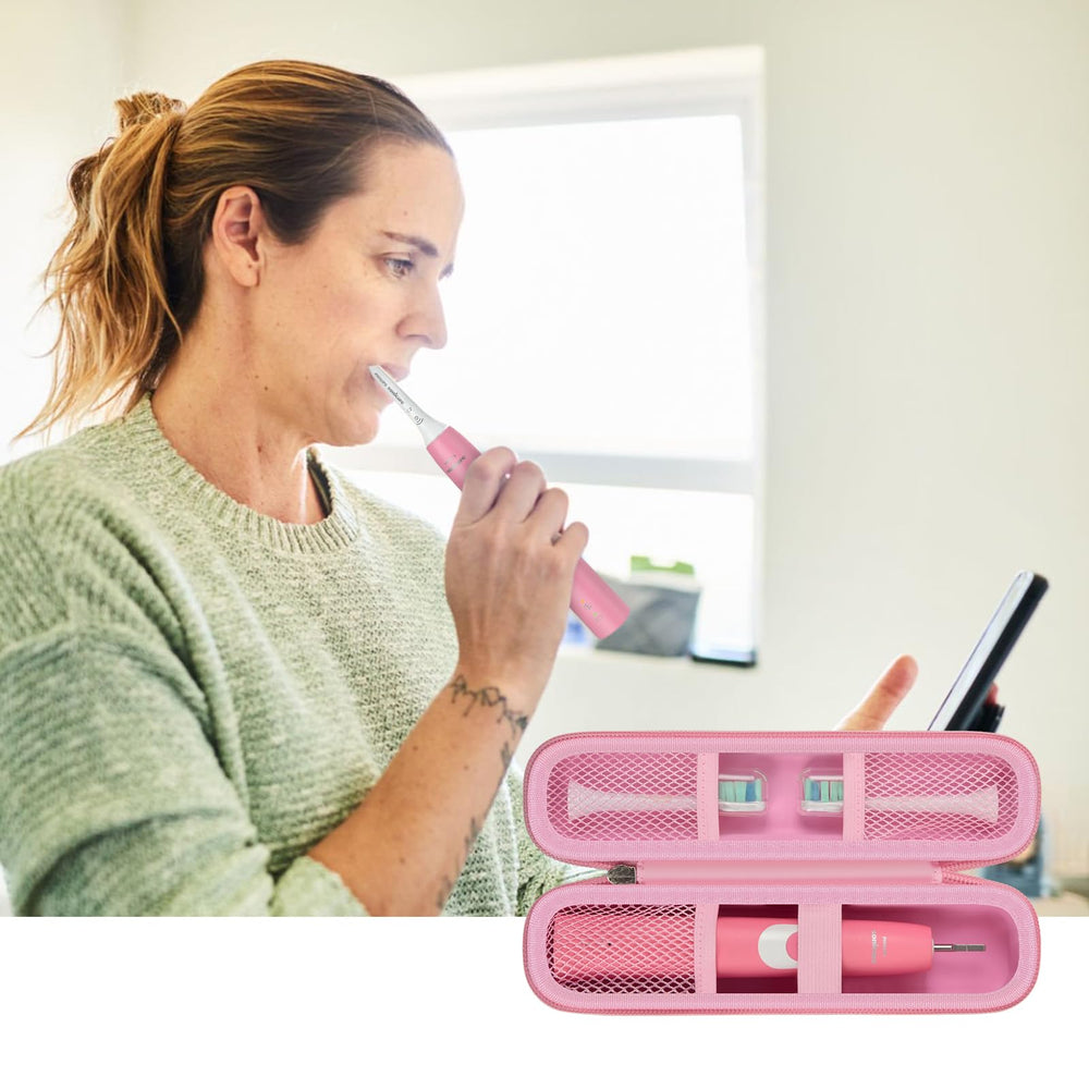 Interior of pink travel case showing mesh pockets for toothpaste and brush heads