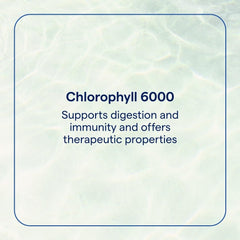 Dropper dispensing chlorophyll liquid into a glass of water