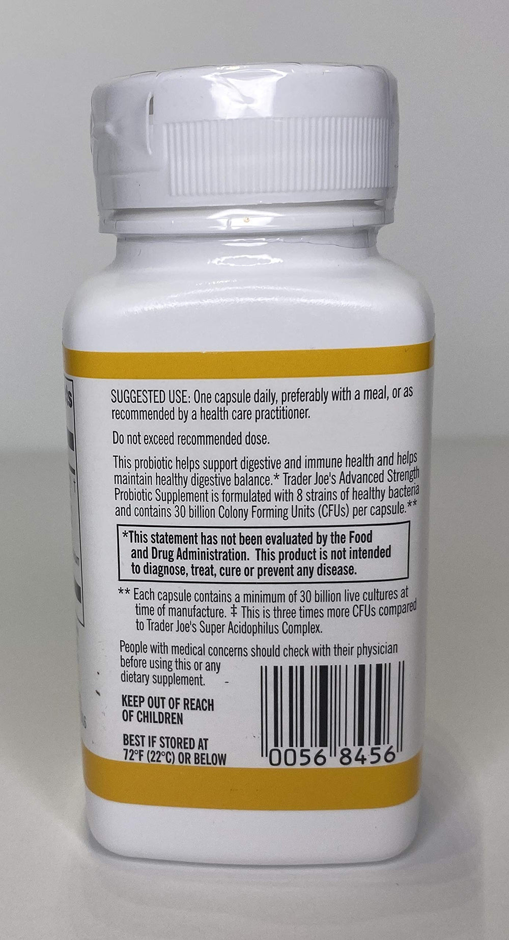 Five capsules next to the bottle for scale
