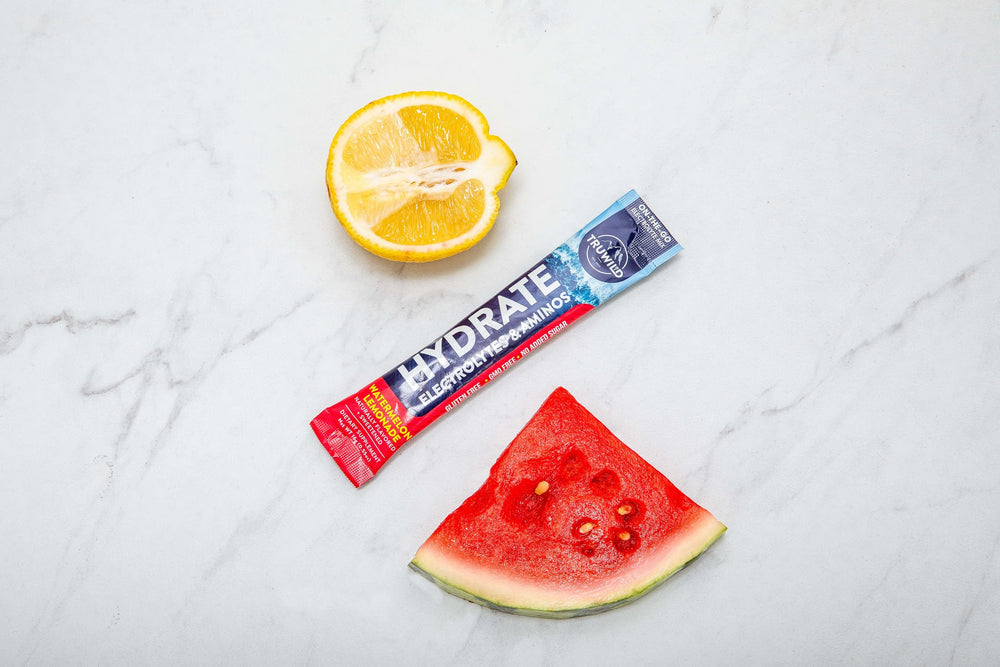 Gym bag scene with TruWild Hydrate on-the-go packets ready to mix