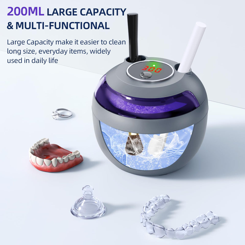 Cleaner in use with toothbrush heads and jewelry in Grey