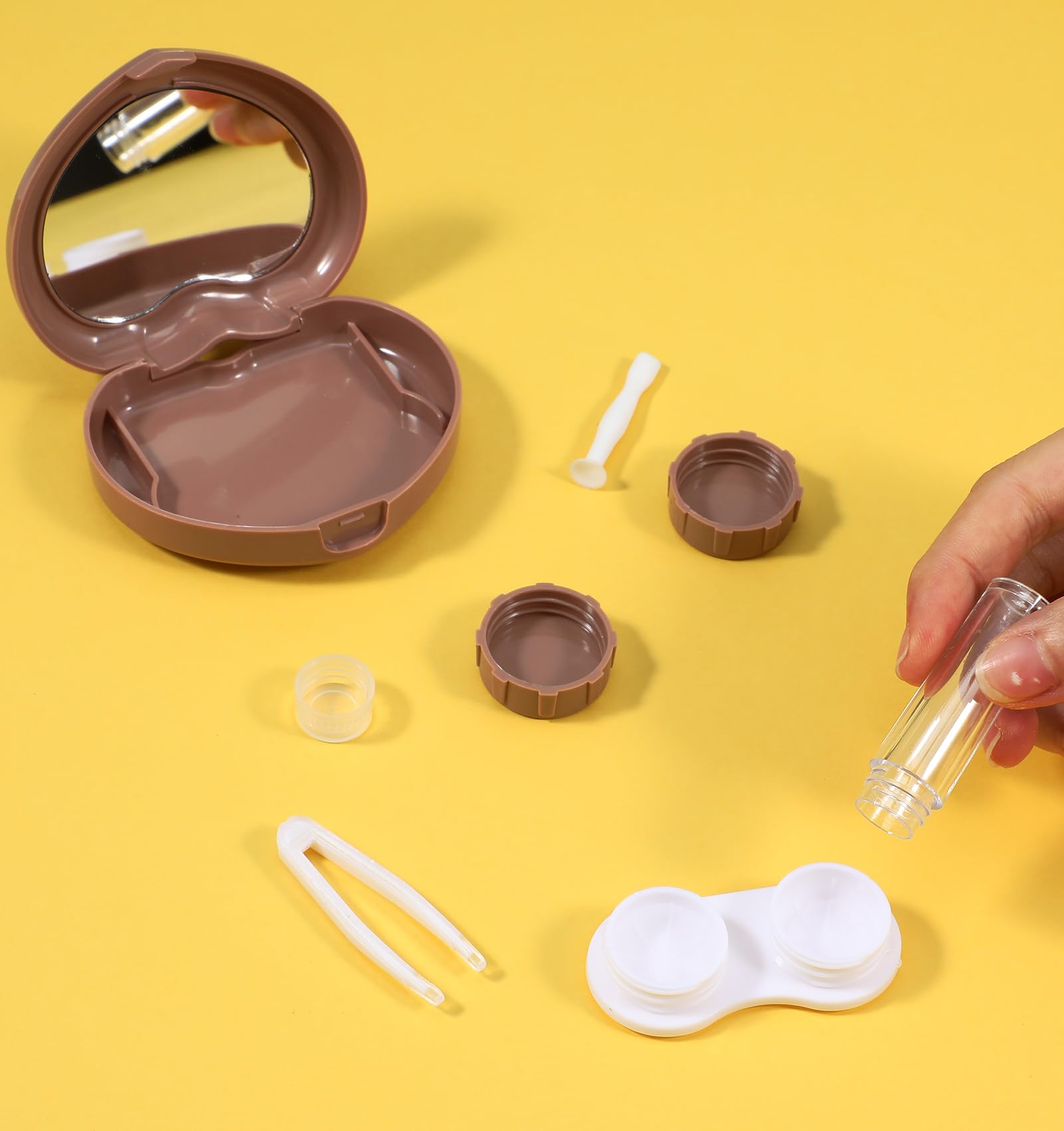 Opened brown heart-shaped lens case showing left and right compartments