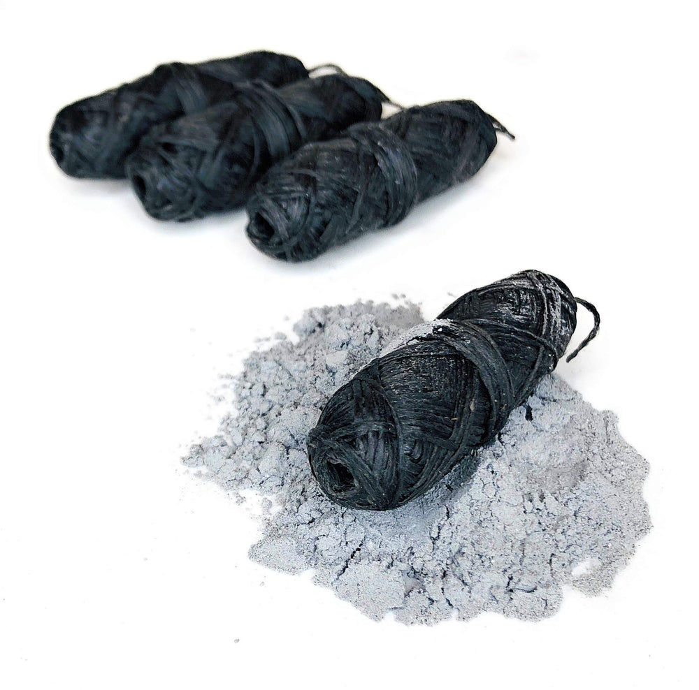 Close-up of bamboo charcoal dental floss refill wrapped in natural candelilla wax