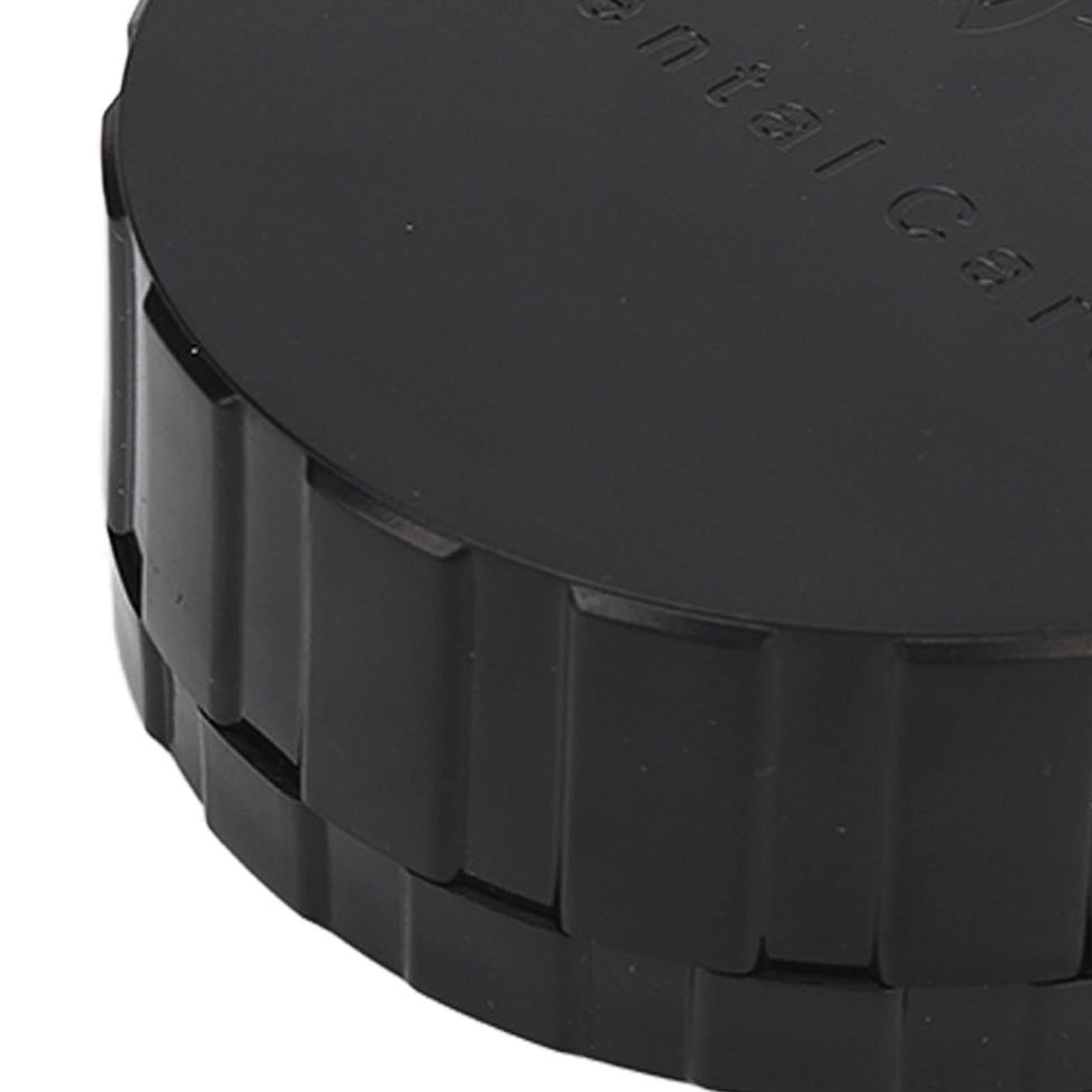 Round black denture storage box on bathroom counter