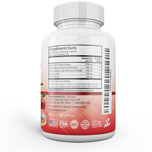 Garlic, ginger, lemon and honey arranged around bottle