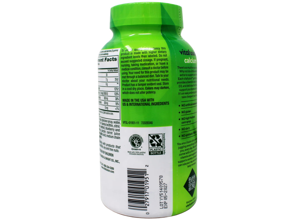 Two gummies with a glass of milk to show calcium content