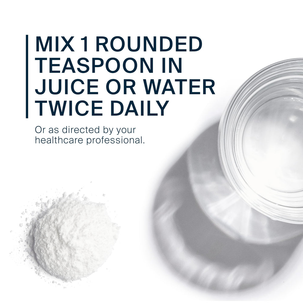 Serving size scoop with powder and glass of water