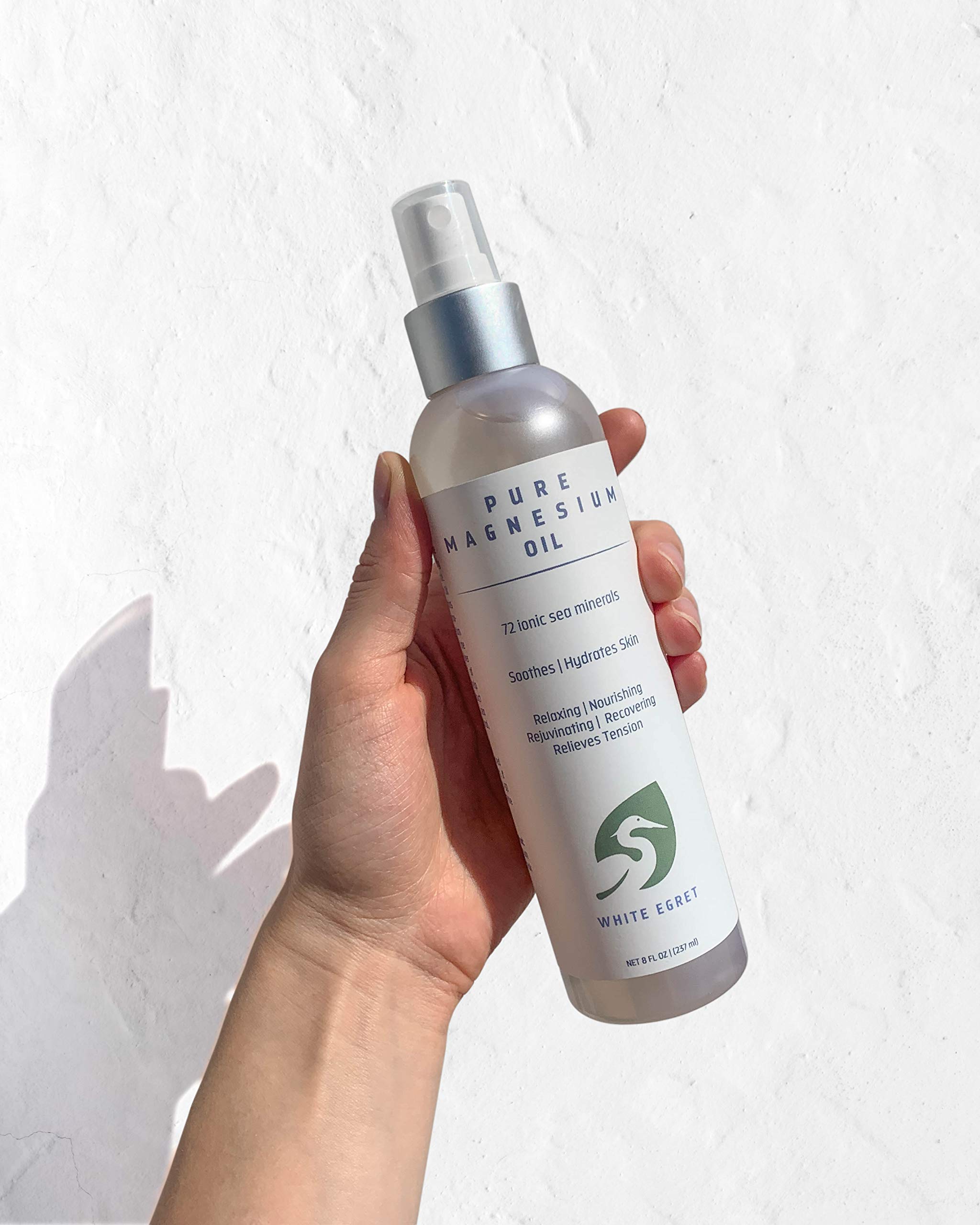 Close-up of magnesium beauty oil bottle with subtle floral fragrance