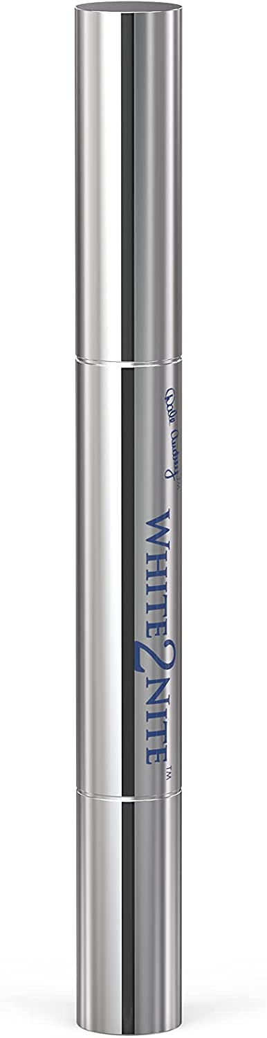 Applying White2nite whitening pen to teeth