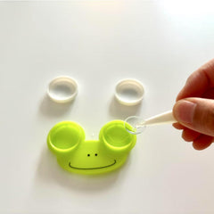 Green frog-shaped contact lens case – front view