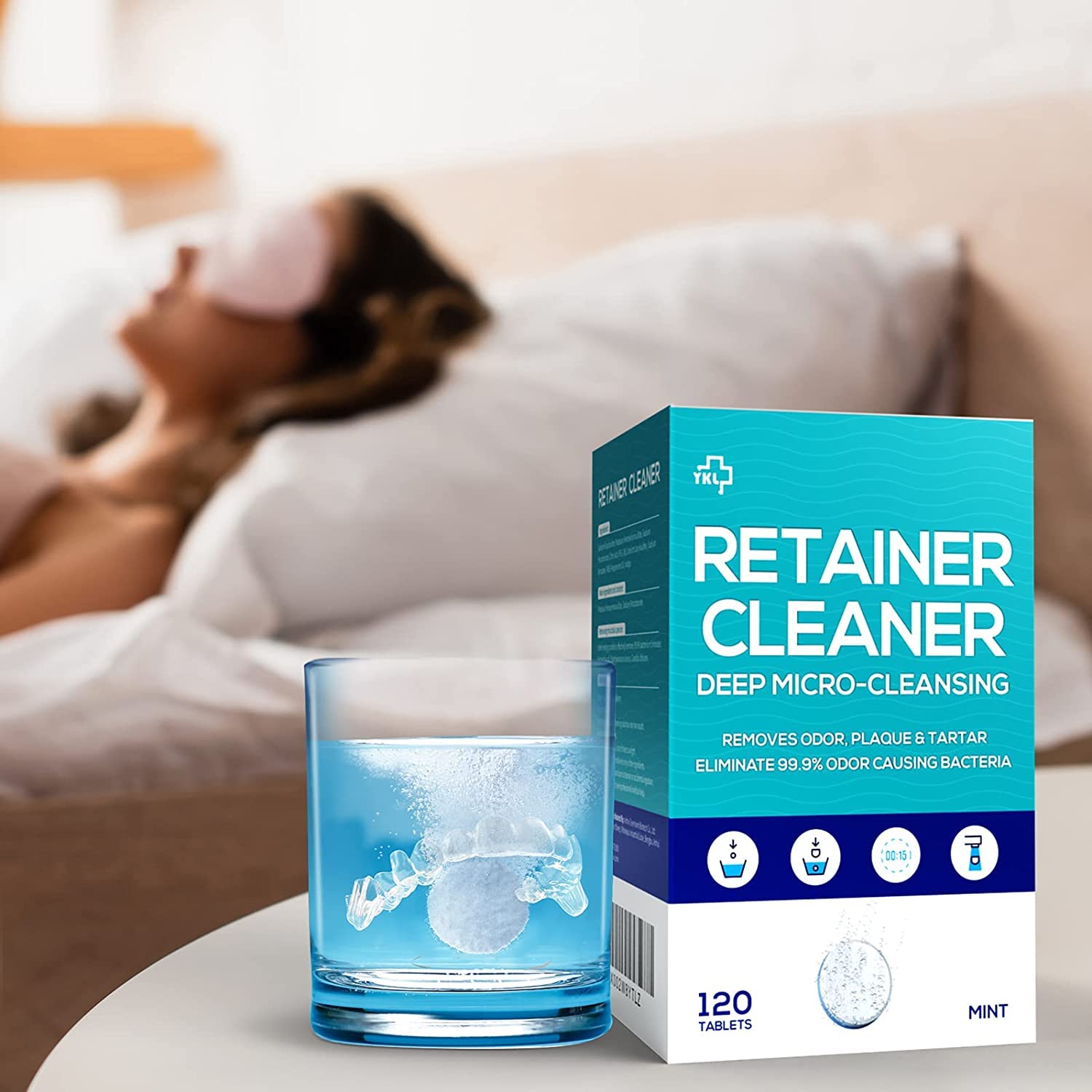 Denture and retainer soaking in cleaning solution with tablet