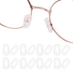Transparent white silicone eyeglass nose pads displayed on a white background