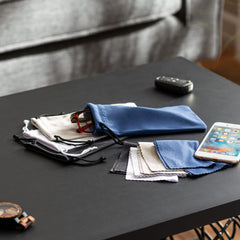 Four black microfiber glasses pouches laid out