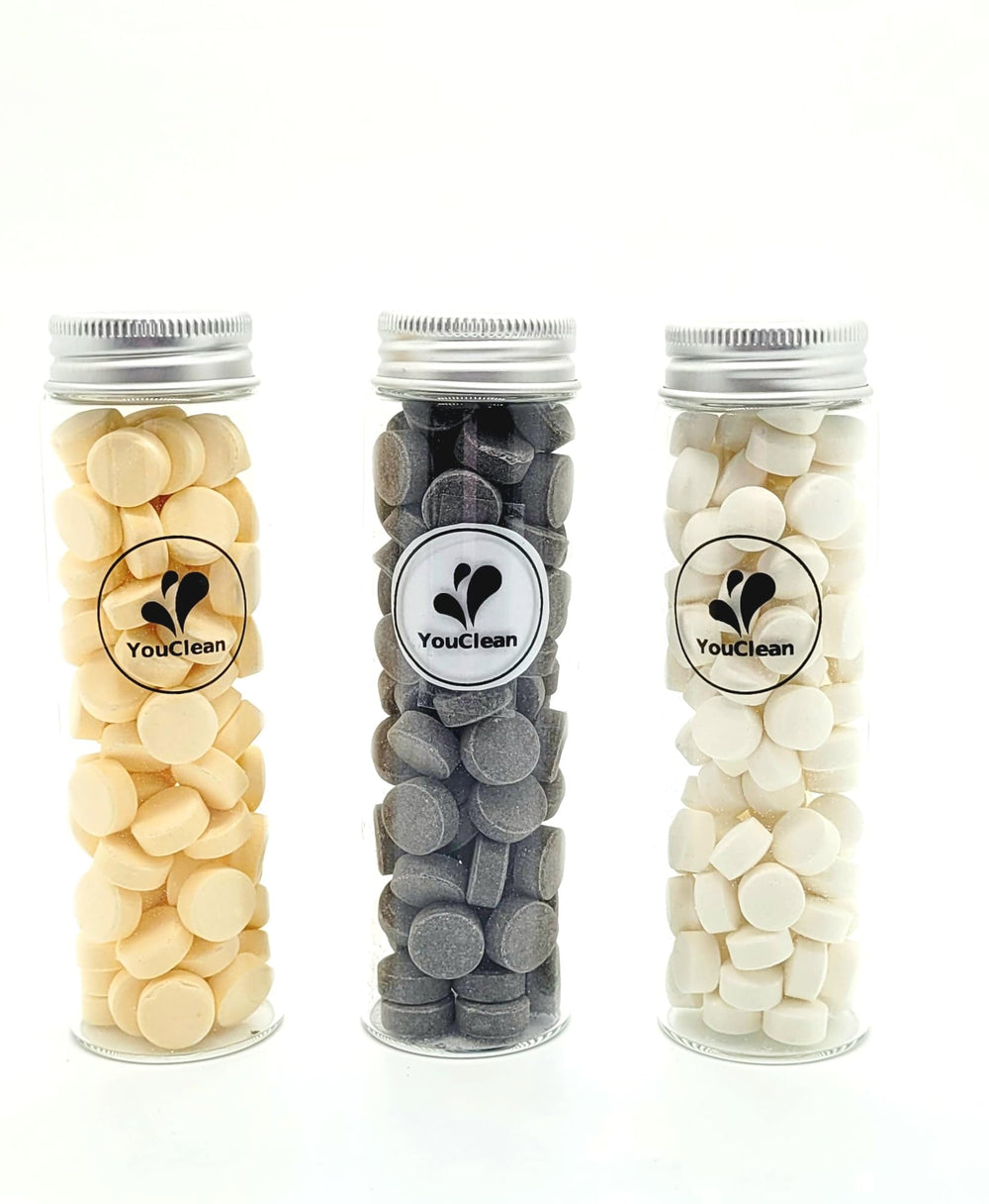 Travel-friendly YouClean toothpaste tablets in a glass cylinder container