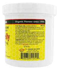 Teaspoon of Royal Jelly in Honey Ultra Strength gel on wooden surface