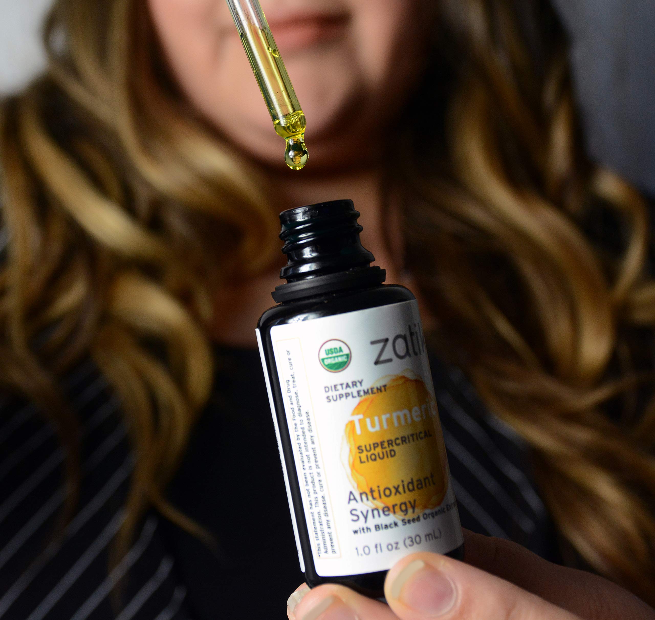 Ingredients label showing organic black cumin oil and turmeric extract