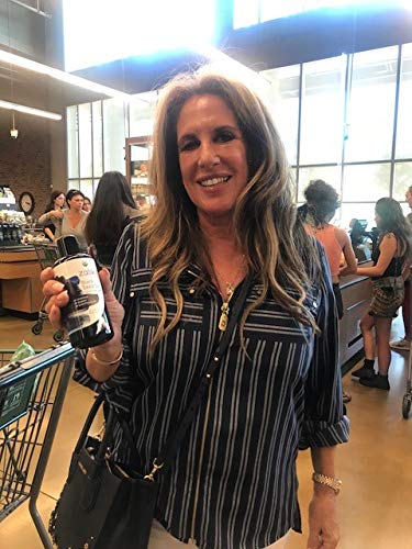Wellness setup featuring black cumin seed oil bottle with plants