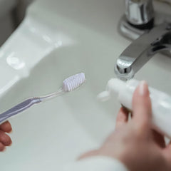 Grey medium toothbrush with soft bristles, individually wrapped