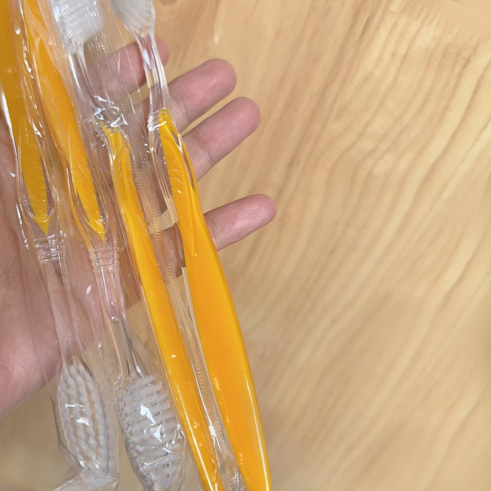 Bulk 100-pack toothbrushes arranged in a row