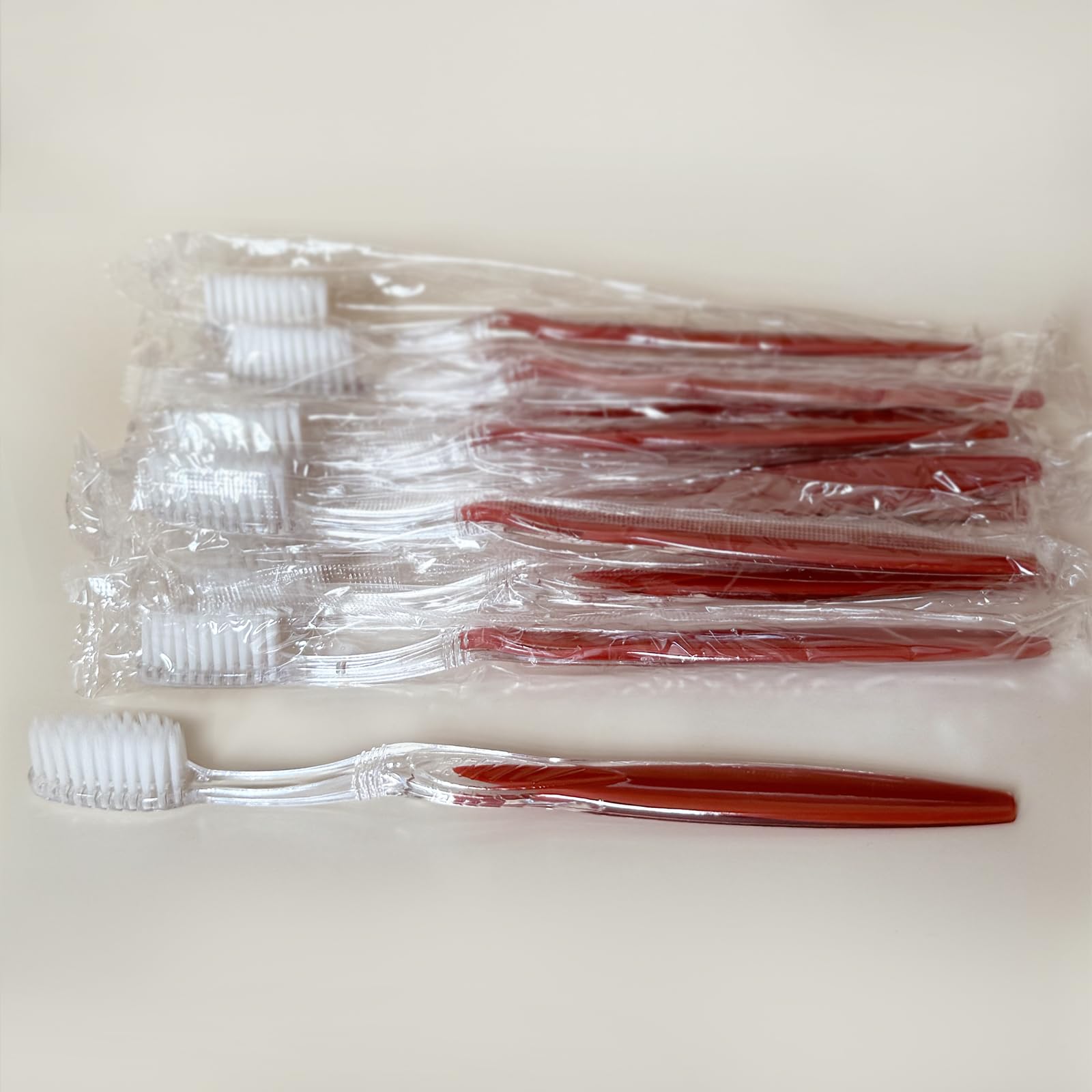 Close-up of a 7.25 inch manual toothbrush with a long solid handle and soft bristles