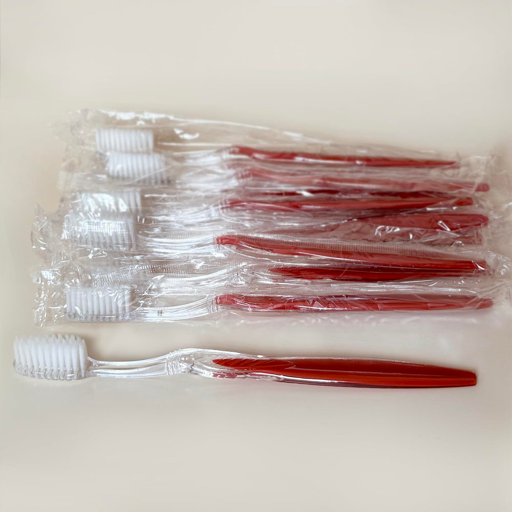Close-up of a 7.25 inch manual toothbrush with a long solid handle and soft bristles